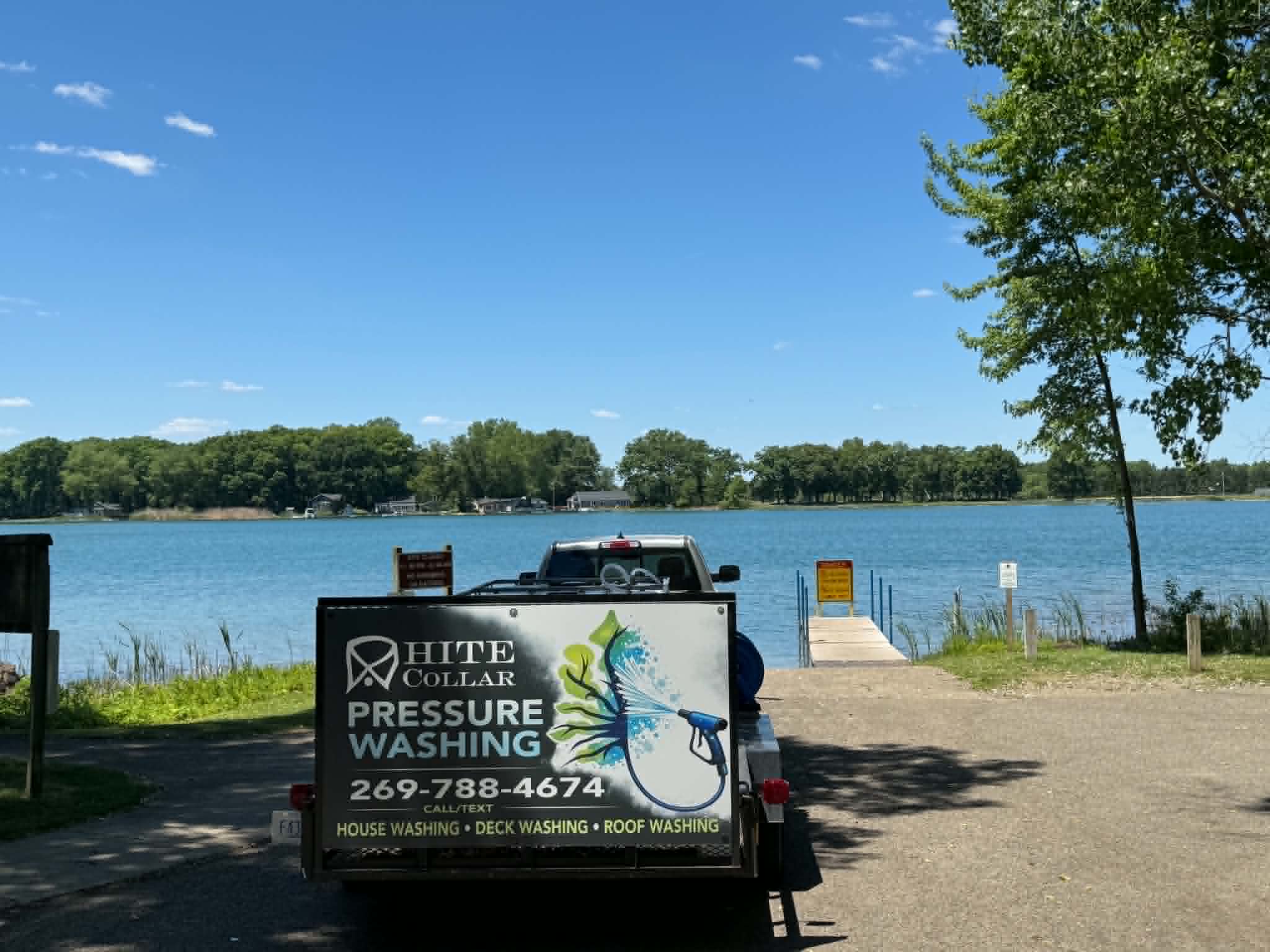 White Collar Pressure Washing trailer parked at a lake in Marshall, Michigan